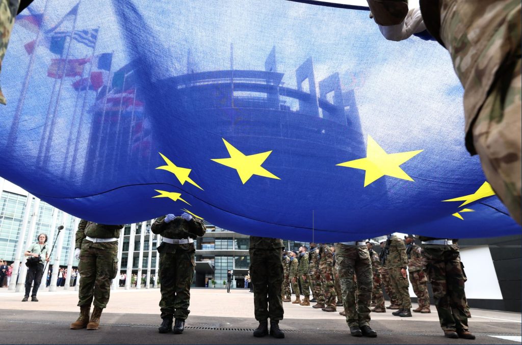 Eurocorps soldiers carry a European Union flag during the flag-raising ceremony on the eve of the inaugural session of the new European Parliament, in front of the Louise Weiss building, the headquarters of the European Parliament in Strasbourg, eastern France, on 15 July 2024. Photo: Frederick Florin / AFP via Getty Images